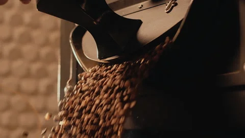 Coffee roasting. Coffee roaster opens roasting machine, hot freshly roasted Stock Footage 272336407