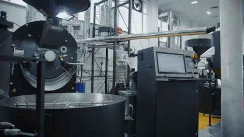 Coffee roasting machine processing aromatic coffee beans in modern factory Foto stock
