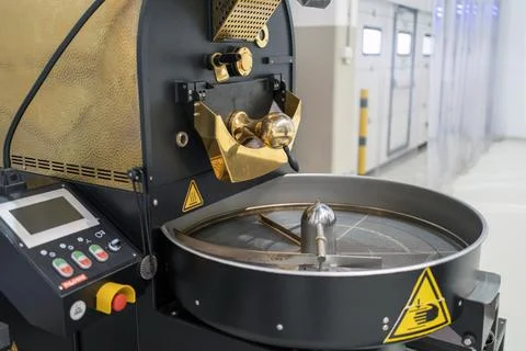 Coffee roasting plant during operation, small roasting machine. Stock Photos