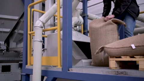At a coffee roasting plant. The machine is in the process of roasting coffee. Video stock 220671566