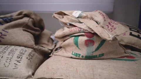 At a coffee roasting plant. The machine is in the process of roasting coffee. Video stock 220675754