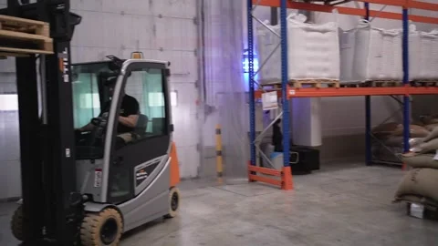 At a coffee roasting plant. The machine is in the process of roasting coffee. Video stock 220679278