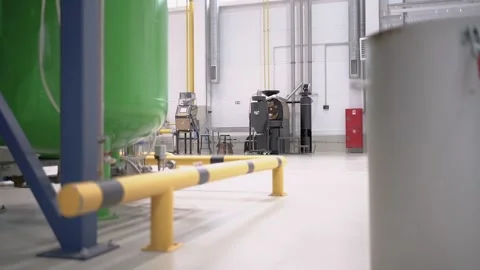 At a coffee roasting plant. The machine is in the process of roasting coffee. Video stock 220681999