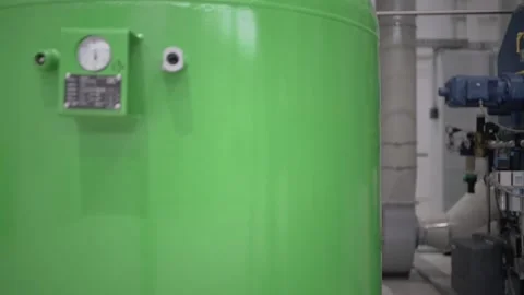 At a coffee roasting plant. The machine is in the process of roasting coffee. Video stock 220682090