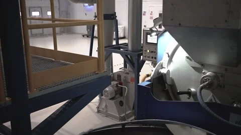 At a coffee roasting plant. The machine is in the process of roasting coffee. Ro Video stock 220683120
