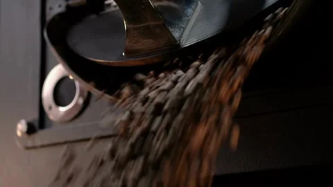 Coffee roasting process in small mixing rotor roaster factory burning cooli.. Stock Footage 272458293