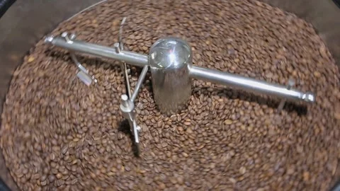 Coffee roasting while the coffee beans rotate in the coffee roasting machine Stock Footage 293167735