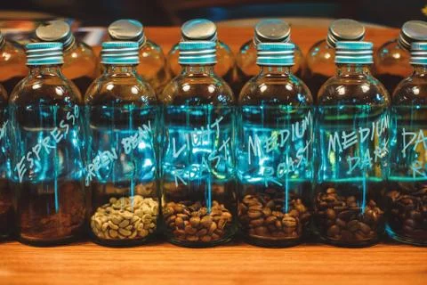 Coffee seed in bottle on the table. Stock Photos