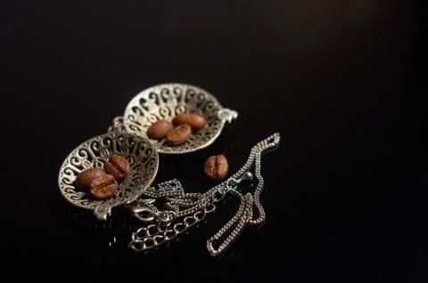 Coffee seeds and pendant on the black background Stock Photos