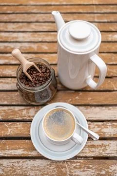 Coffee set with coffee maker, cup and glass jar with coffee beans on a wooden Stock Photos