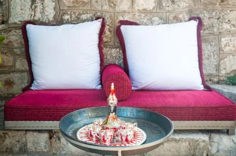 Coffee set on a table in front of sofa. Cup of tea on a tray on a round table Stock Photos