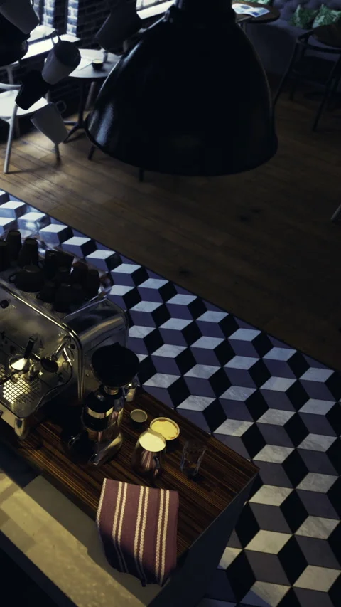 Coffee setup in a cafe with equipment on a patterned floor at morning Stock Footage 331669370