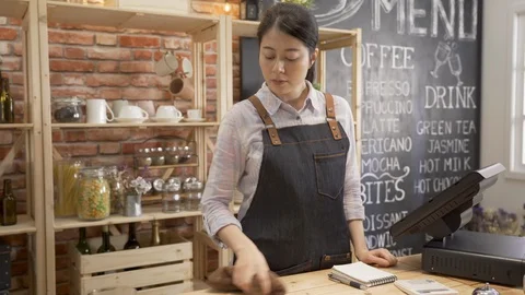 Coffee shop assistant taking order on smartphone Stock Footage 124879655