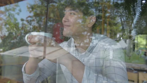 Coffee shop concept of 4k Resolution. Asian men are enjoying coffee in the sh Stock Footage 151422696