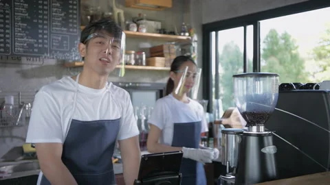 Coffee shop concept of 4k Resolution. A young Asian man is suggesting informa Stock Footage 152029314
