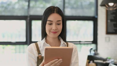 Coffee shop concept of 4k Resolution. Asian woman checking merchandise in a s Stock Footage 208559612