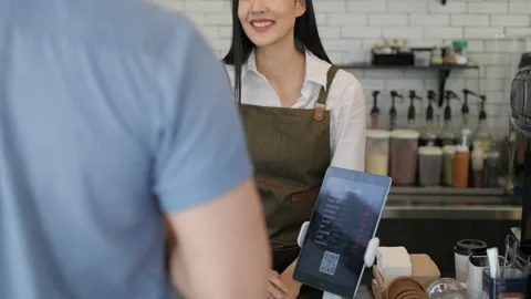 Coffee shop concept of 4k Resolution. Asian female staff are introducing menu Stock Footage 208561210
