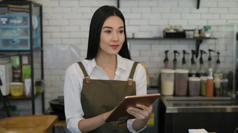Coffee shop concept of 4k Resolution. Asian woman checking merchandise in a s Stock Footage 219886871