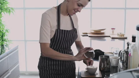 Coffee shop concept of 4k Resolution. The barista makes latte art with the .. Stock Footage 243642664