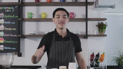 Coffee shop concept of 4k Resolution. The barista is introducing the menu i.. Video stock 243642866