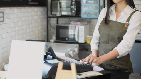Coffee shop concept of 4k Resolution. An Asian woman is charging her money .. Stock Footage 272670309