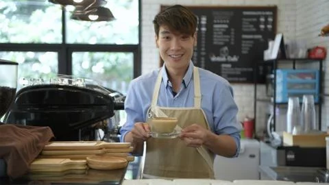 Coffee shop concept. The bartender is making coffee with a smiling face. 4k R Stock Photos