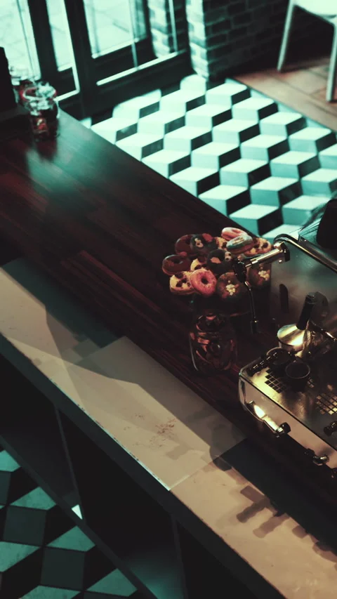 Coffee shop with a display of donuts on the counter during the day Stock Footage 340643995