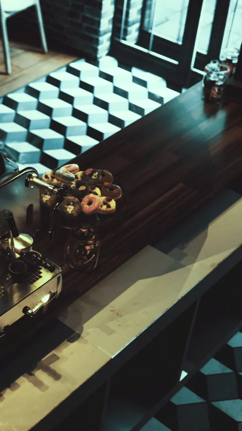 Coffee shop with donuts on display and a unique floor design Stock Footage 331669400