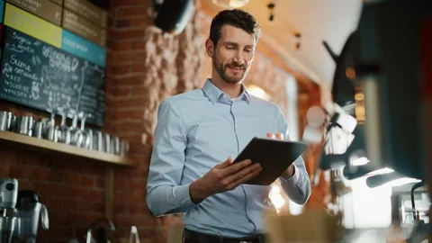 Coffee Shop Owner Using Tablet Computer Stock-Footage 143734009