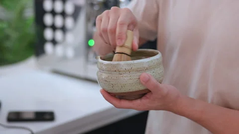 Coffee shop staff doing matcha bhucha for customers Stock Footage 246425554
