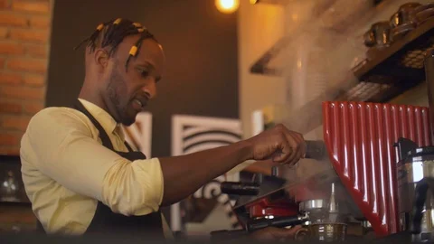 Coffee shop worker making espresso with a lot of steam on coffee machine Stock Footage 111339676