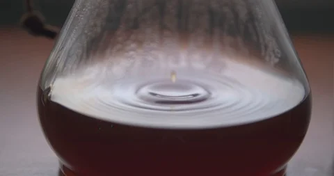 Coffee Slowly Dripping into a Chemex Causing Ripples Stock Footage 100088338