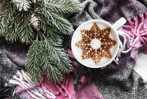 Coffee with a snowflake pattern on a warm woolen plaid Stock Photos