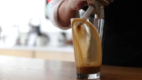 Coffee Sparkling Nitro Cold Brew Coffee pouring to glass and ready to drink. Stock Footage 89942641