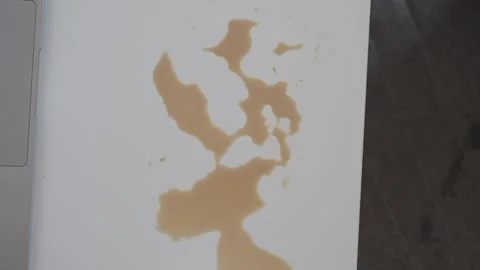 Coffee spill forms an abstract pattern on white Stock Footage 316444320