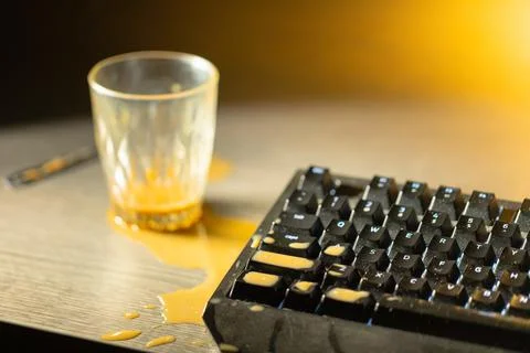 Coffee spilled on mechanical keyboard of computer Stock Photos