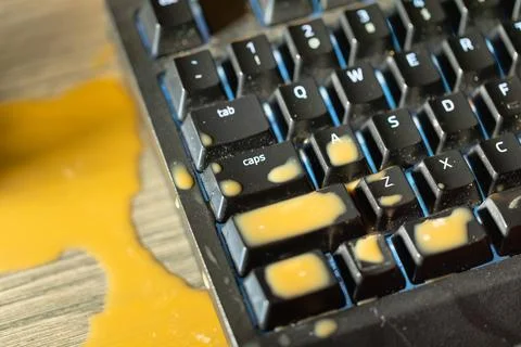 Coffee spilled on mechanical keyboard of computer Foto stock