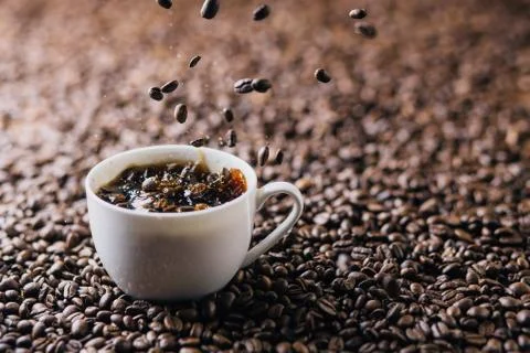 Coffee splash with coffee beans Stock Photos