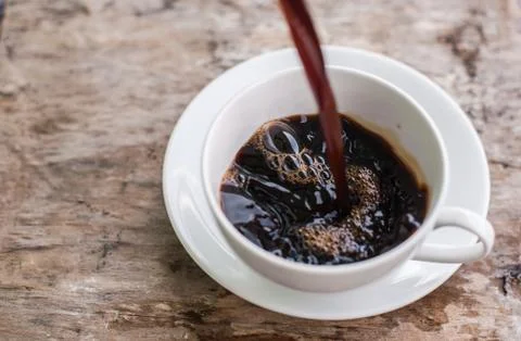 Coffee splash into a cup of coffee Stock Photos