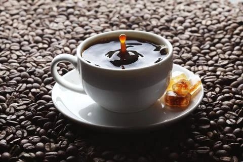 Coffee splash in cup Stock Photos