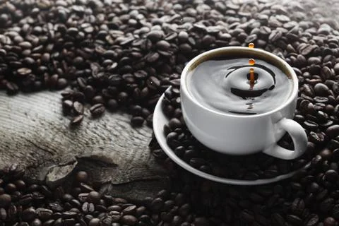 Coffee splash in cup Stock Photos