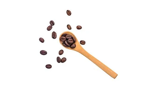 Coffee in a spoon isolate on a white background. Selective focus. Stock Photos