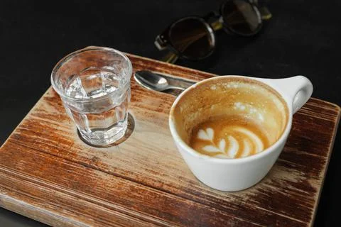 Coffee stains on almost empty in white coffee cup on wooden board in vintage Stock Photos