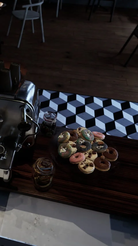Coffee station with donuts on a table in a cafe setting during the morning Stock Footage 340633049