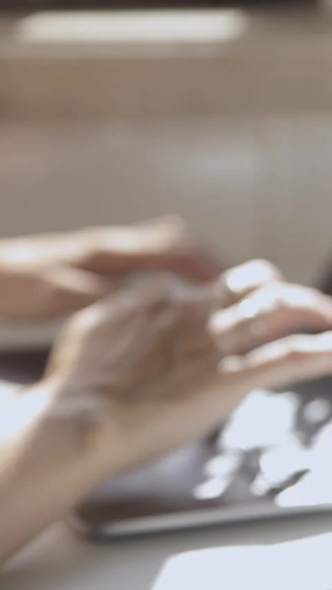Coffee is steaming in a glass against the background of blurry female hands Stock Footage 328295331