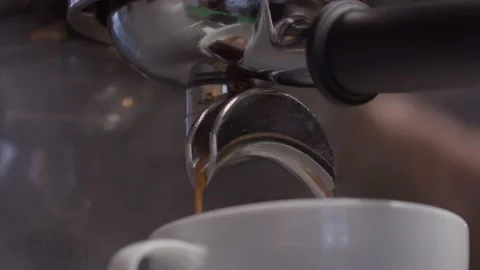 Coffee stream from machine in cup close-up Stock Footage 199473536