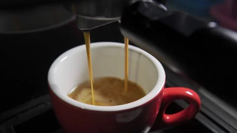 Coffee stream from machine in cup. Home making hot Espresso. Stock Footage 151431146