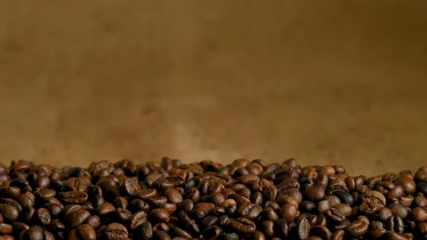 Coffee is strewn on the burlap, falls on the background Stock Footage 85591874