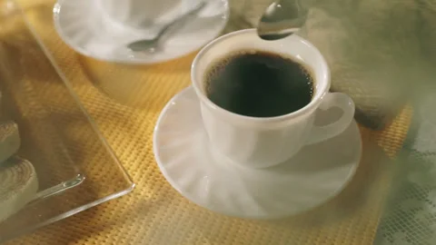 Coffee Table with Bolo de Rolo, Steam, White Cup, Hand Stirring with Spoon Stock Footage 303519110