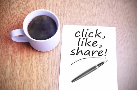 Coffee on the table with note writing click, like, share! Foto stock